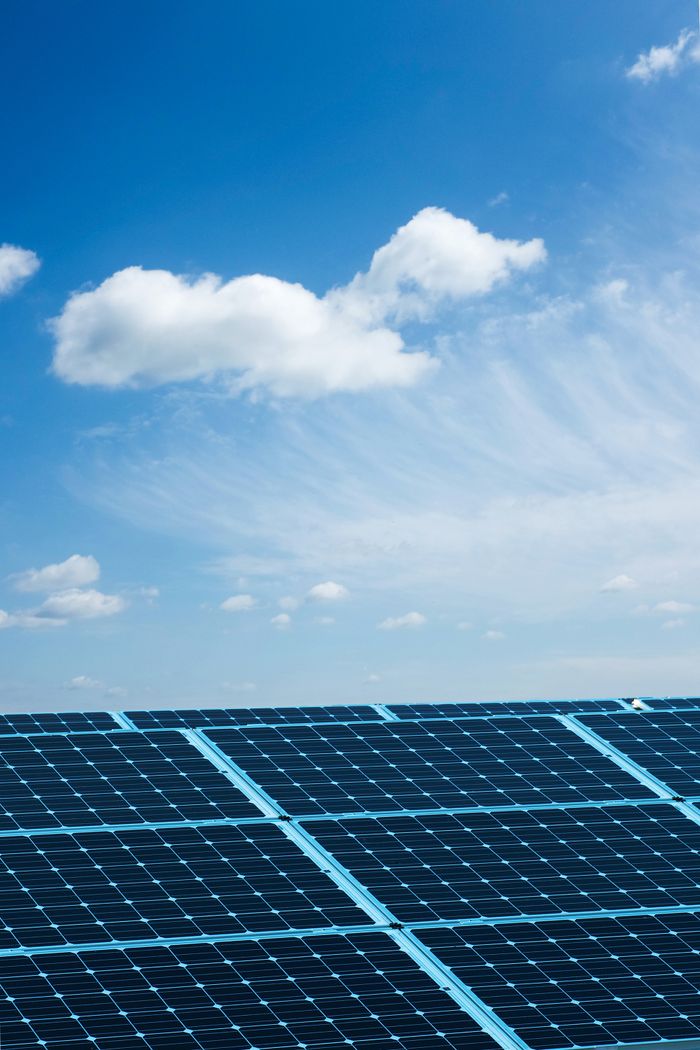 services-02 Solar panels under a clear blue sky, symbolizing renewable energy and sustainability.